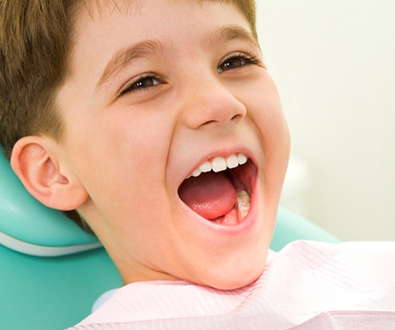 Young boy happy at child’s dentist.
