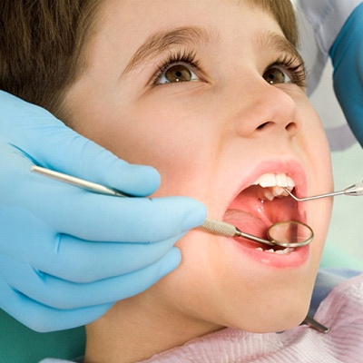 Young boy at semi-annual dental appointment.