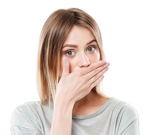 Anxious woman covering her mouth