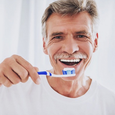 older man about to brush teeth