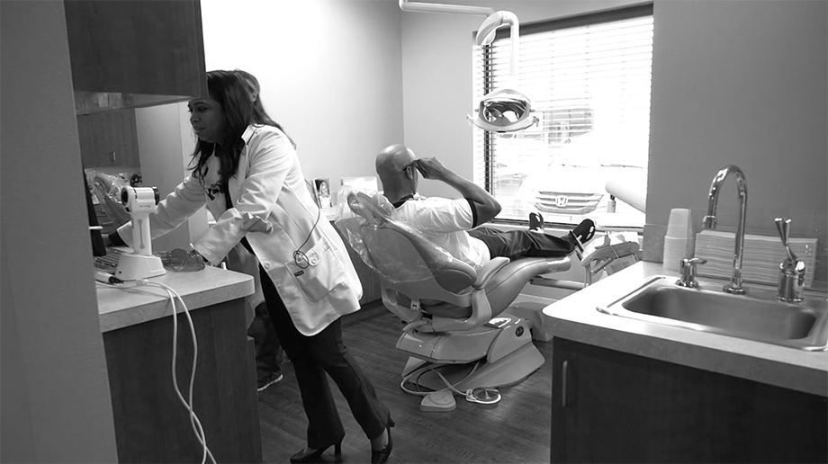 Doctor Parmar working with dental patient in Frisco