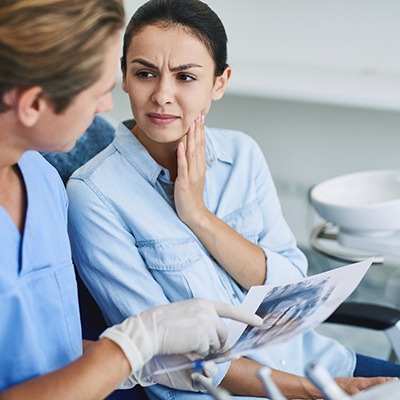 Patient listening to her emergency dentist in Frisco
