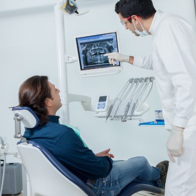 Frisco emergency dentist showing X-ray to a patient