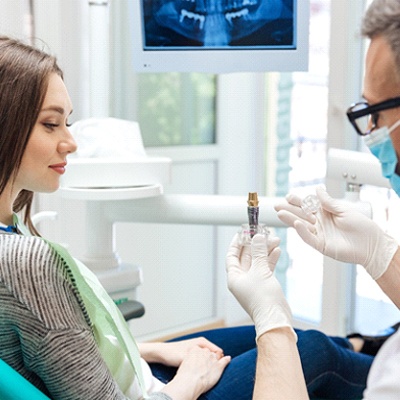 dentist in Frisco explaining dental implants to patient