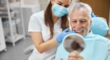 older man smiling after getting dental implants in Frisco