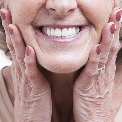 Closeup of older woman’s smile with dental implants in Frisco