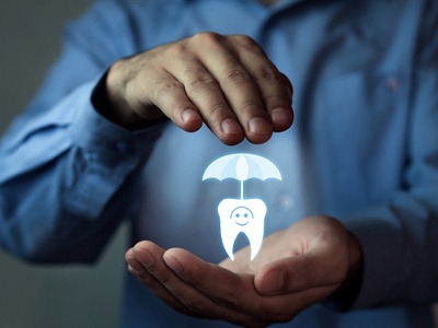 MetLife dentist holding a digital tooth and umbrella.
