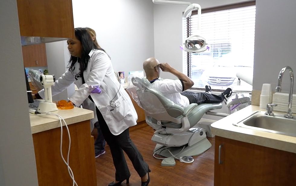 Dentist and patient in dental exam room