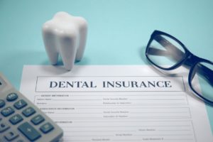 Dental insurance form, glasses, and molar
